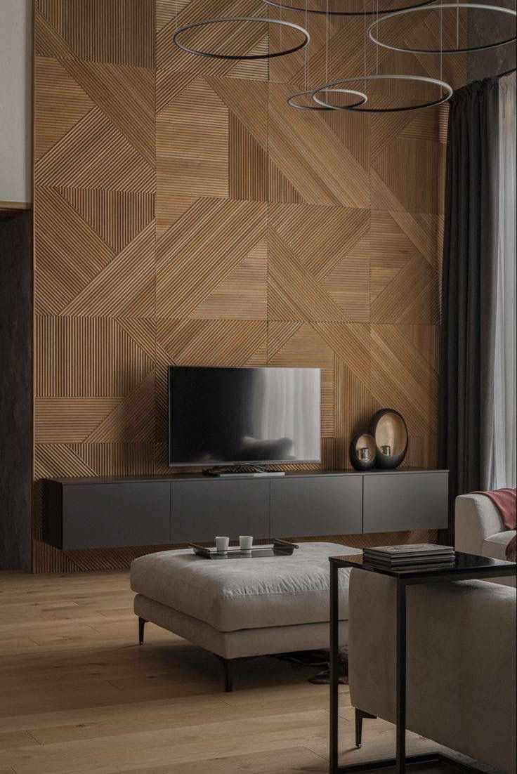 Geometric herringbone wooden puzzle panels on a wall behind a TV console